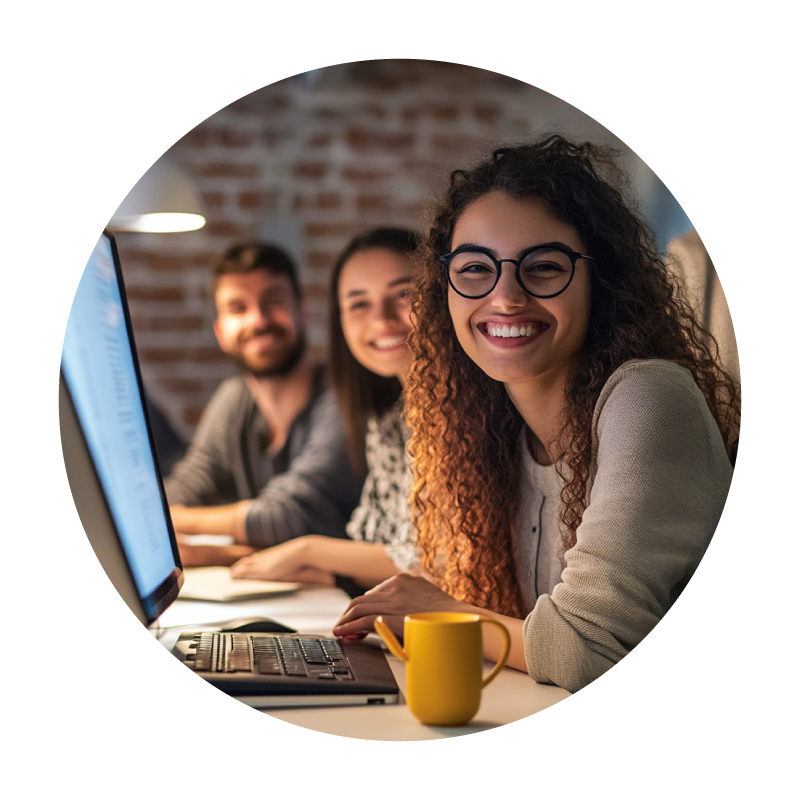 group of agents working on computers smiling at camera