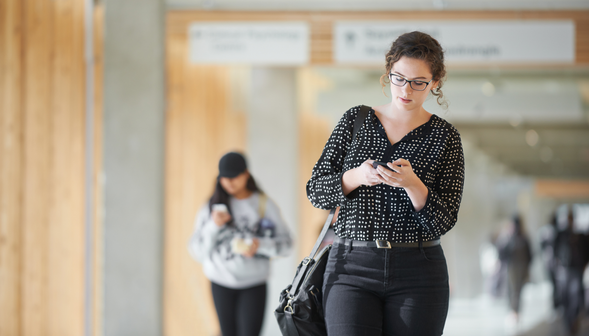 student walking with phone