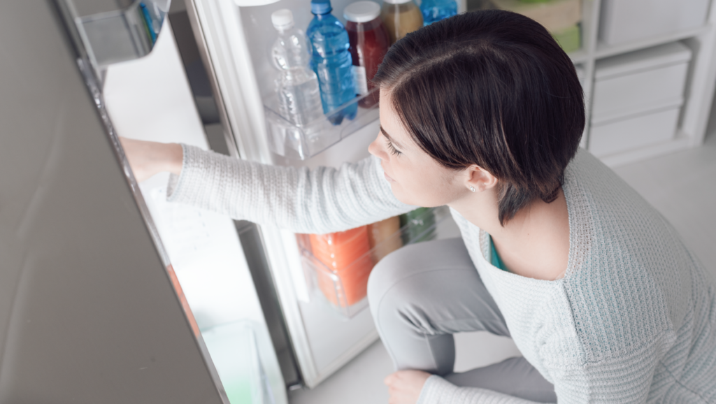 woman looking in fridge