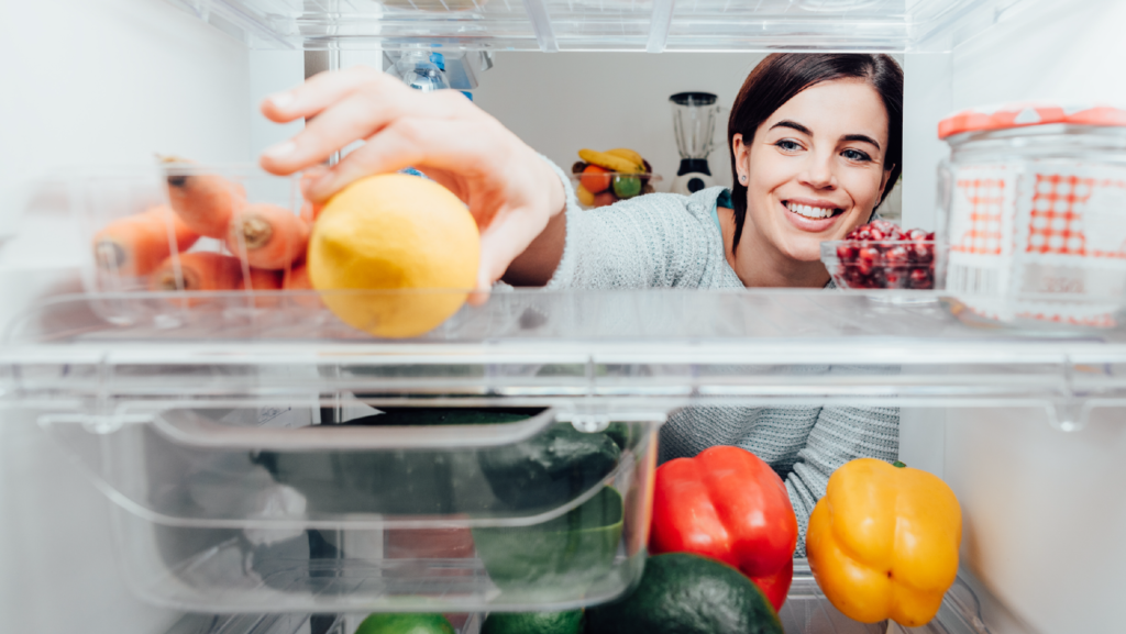 woman happy getting food out of fridge