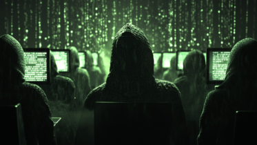 people hacking on computers in a dark room