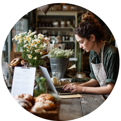 small donut shop worker using laptop for hr